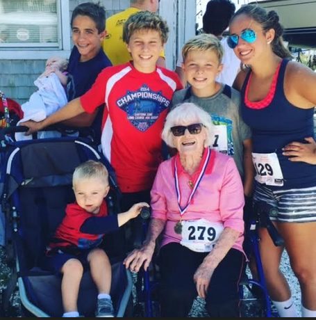 Rita with 6 great-grandkids, 2nd Place Women's Finisher medal around her neck, surrounded with awe and love!